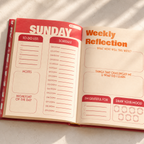 Open planner with sections for 'Sunday Schedule' and 'Weekly Reflection' on a light background